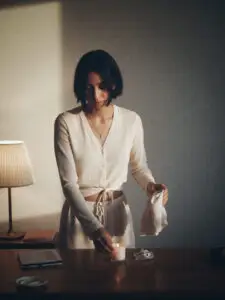 Woman doing a calming Sunday night reset routine at home
