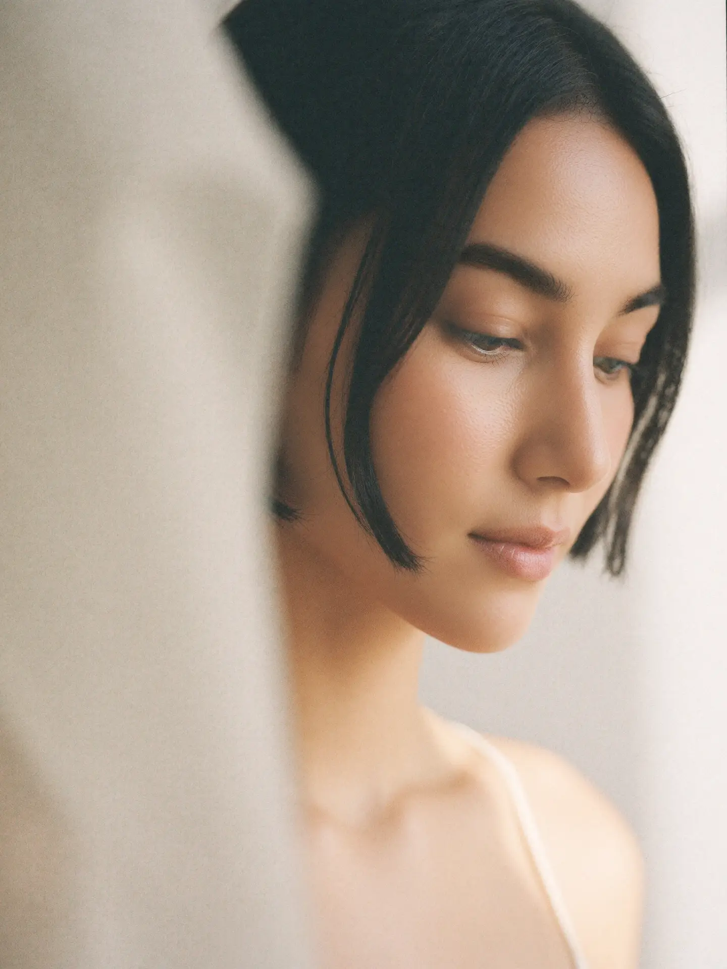 Extreme close-up of dewy skin with a soft, hydrated, lit-from-within glow and no makeup